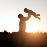 father son playing park sunset time happy family having fun outdoor